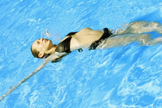 Woman relaxing in outdoor pool