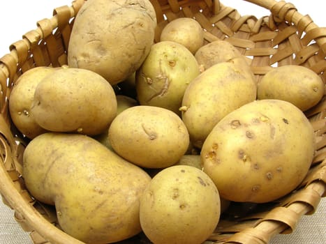 Basket of potatoes on beige blanket