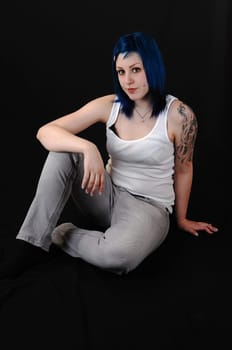 Blue hair girl sitting.