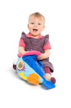 Baby girl playing with toy - isolated