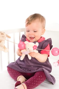 Baby Girl playing in bed