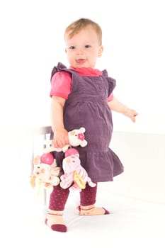 Baby girl standing on crib
