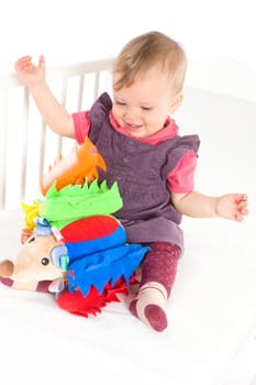 Baby playing with soft toy