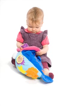Baby girl playing with toy - isolated