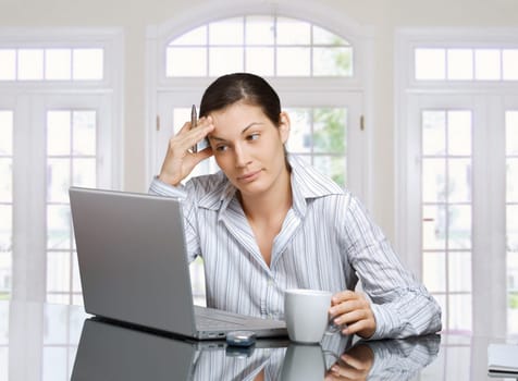 Thinking woman with laptop