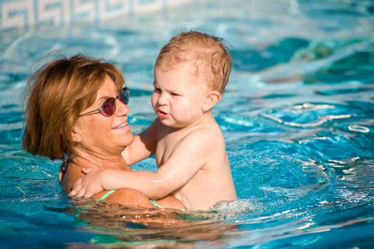 Grandmother swimming with grandson