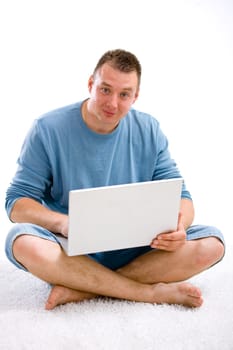 Young casual man with laptop