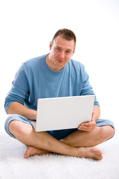 Young casual man with laptop