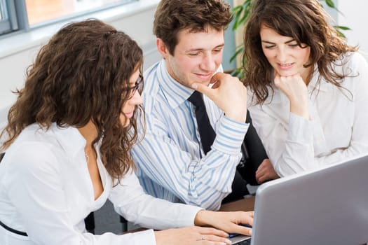 Businesspeople using laptop