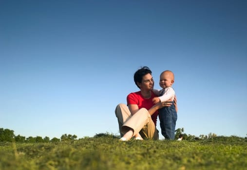 Baby, mother, grass and sky