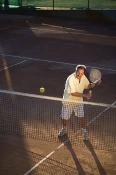 Senior man playing tennis