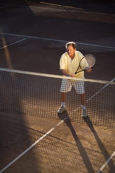 Senior man playing tennis