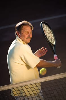 Senior man playing tennis