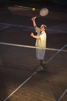 Senior man playing tennis