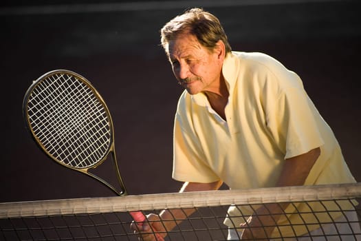 Senior man playing tennis