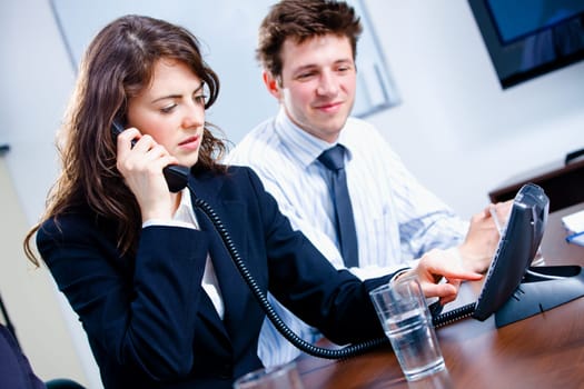 Businesspeople calling on phone