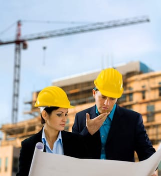 Architects reading blueprint