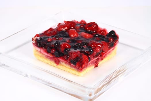 fruit cake in glass plate on white background