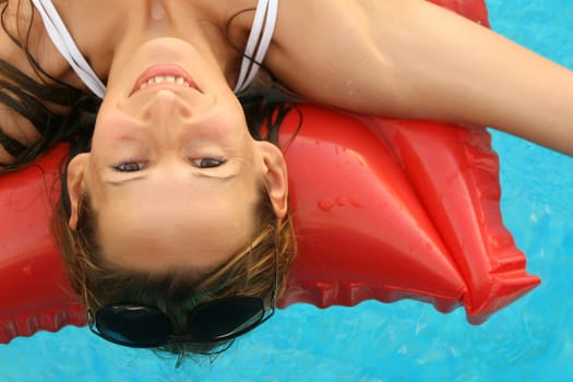 happy woman floating on air mattress