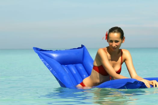 Woman on air mattress in the sea