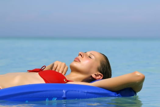 Woman on air mattress in the sea