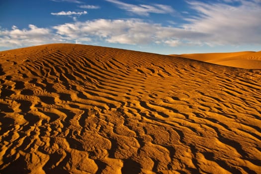sand dunes in desert with blue sky