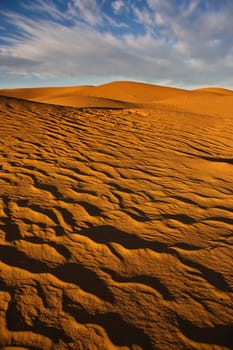 sand dunes in desert with blue sky