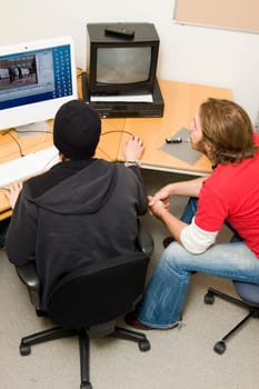 students editing video on computer
