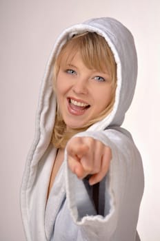 woman in bathrobe pointing at you