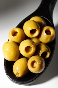 Green olives on spoon shade