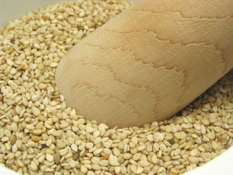 Sesame seeds in porcelain bowl with mortar