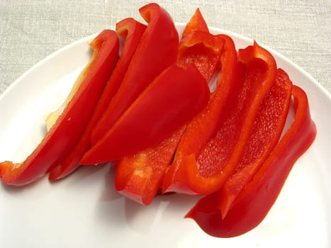 Red bell pepper cut into strips on plate