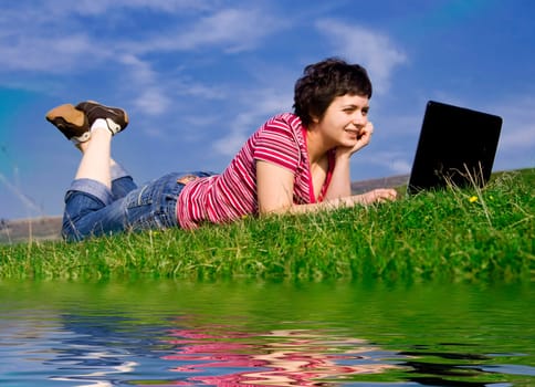 Young casual woman working on laptop