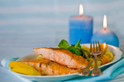 Salmon fillet with noodles served on plate