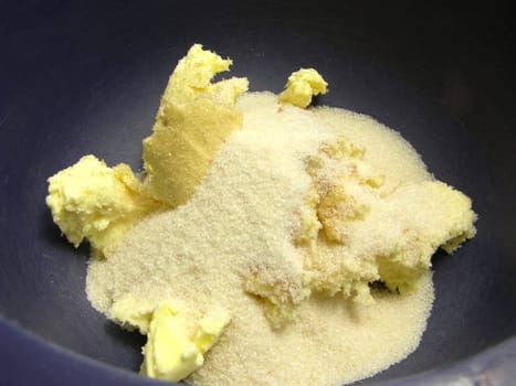 Margarine and cane sugar in a blue bowl