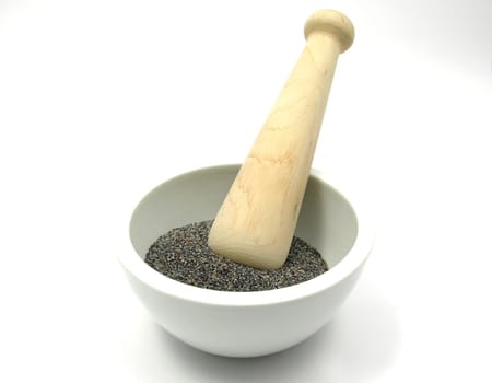 Poppy seeds in porcelain bowl with mortar