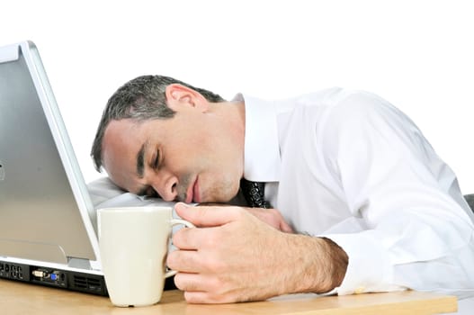 Businessman asleep at his desk on white background