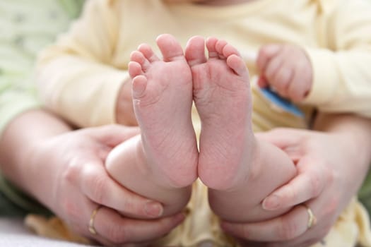 Mother holding her childs feet