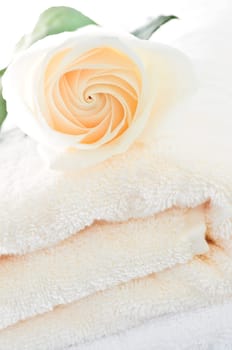Stack of towels and rose