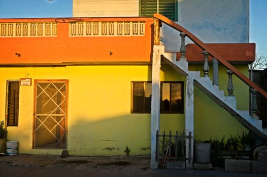 White stairs and Yellow building at Suns