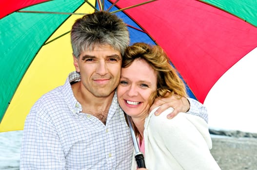 Happy mature couple with umbrella