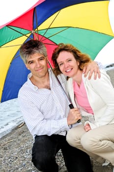 Happy mature couple with umbrella