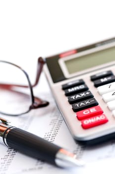 Tax calculator pen and glasses