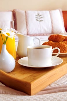 Breakfast on a bed in a hotel room