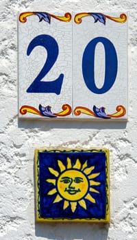 House number 20 and sun symbol on tiles