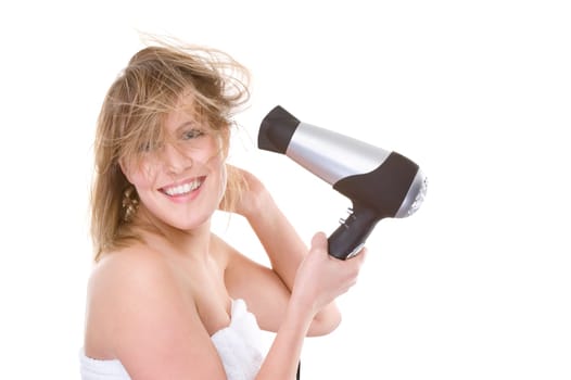 Young woman blow-drying her hair