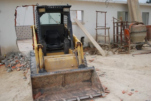 Yellow caterpillar and cement mixer