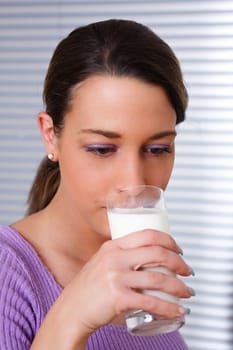 Woman drinking a glass of healthy milk