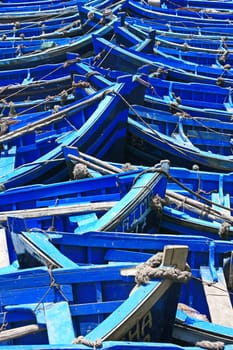 blue fishing boats in sunlight