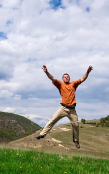 Young handsome man jumping for joy